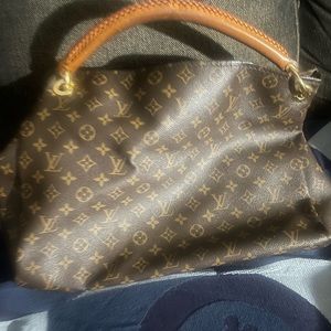 Authentic Louis Vuitton bag that can be carried on the arm or shoulder.